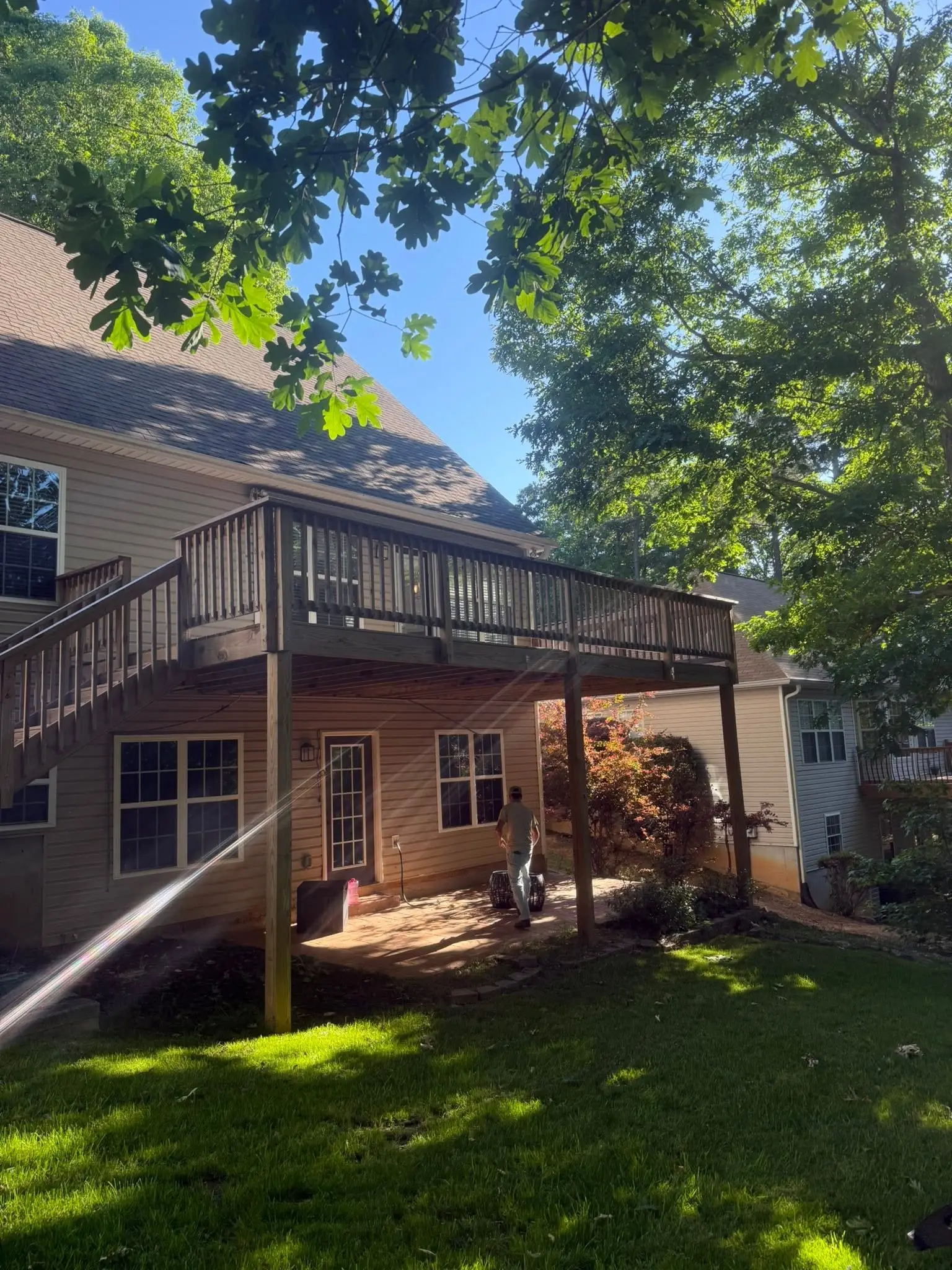 Second-story deck built the year before, freshly stained, with a long side staircase