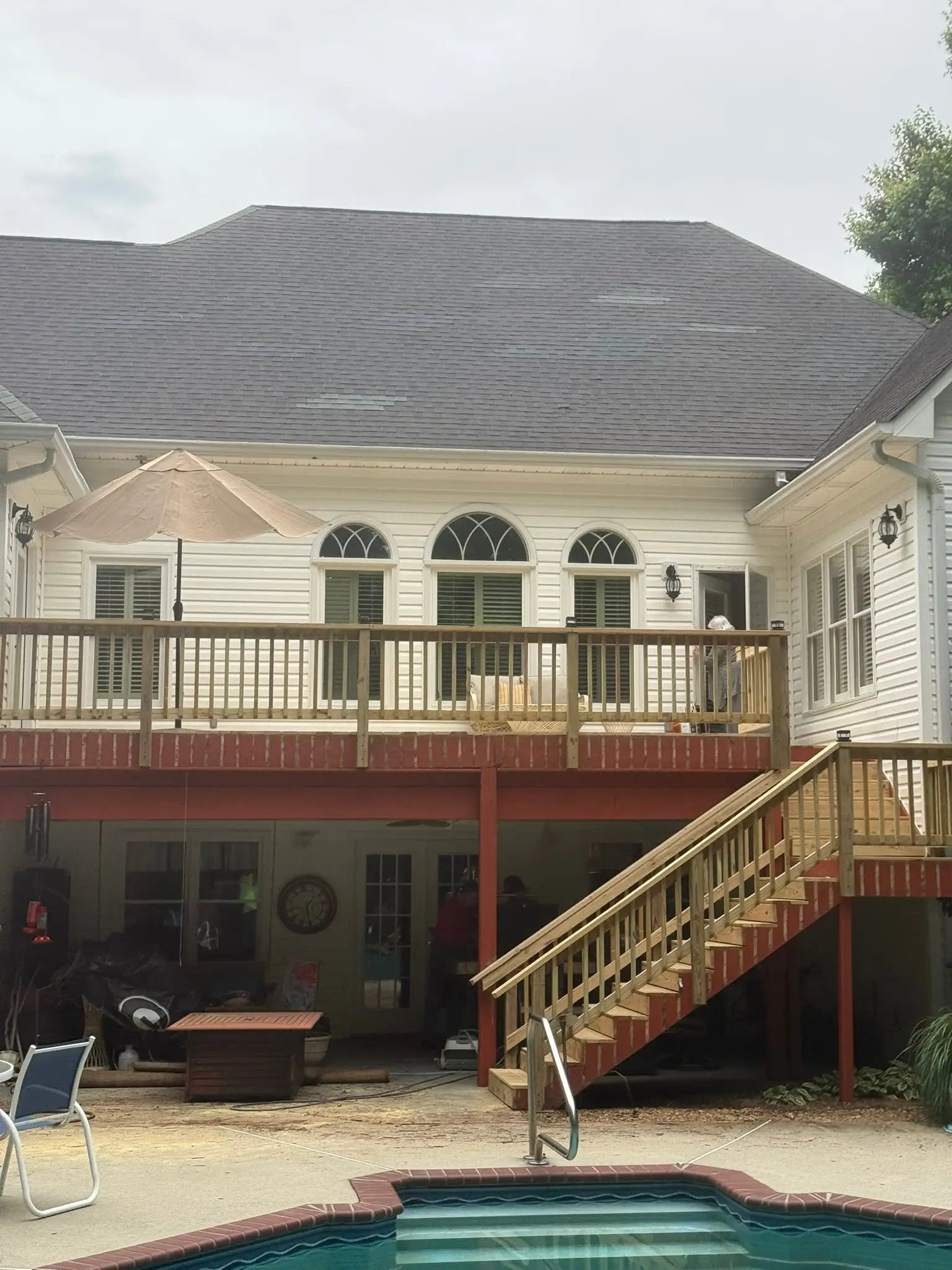 Unstained new deck boards and rail with post lights, ready for stain