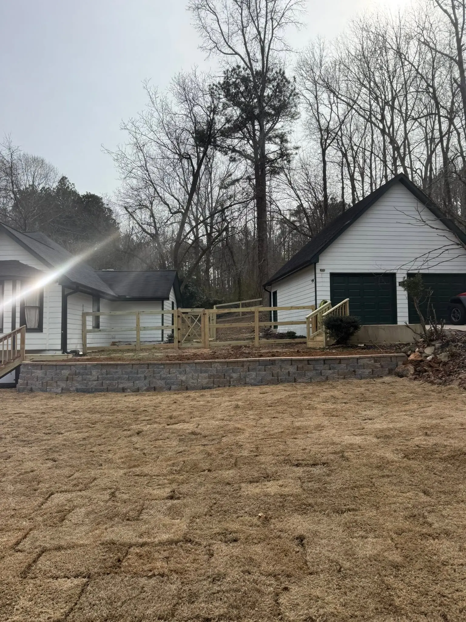 Wood fence and block retaining wall on a farm property