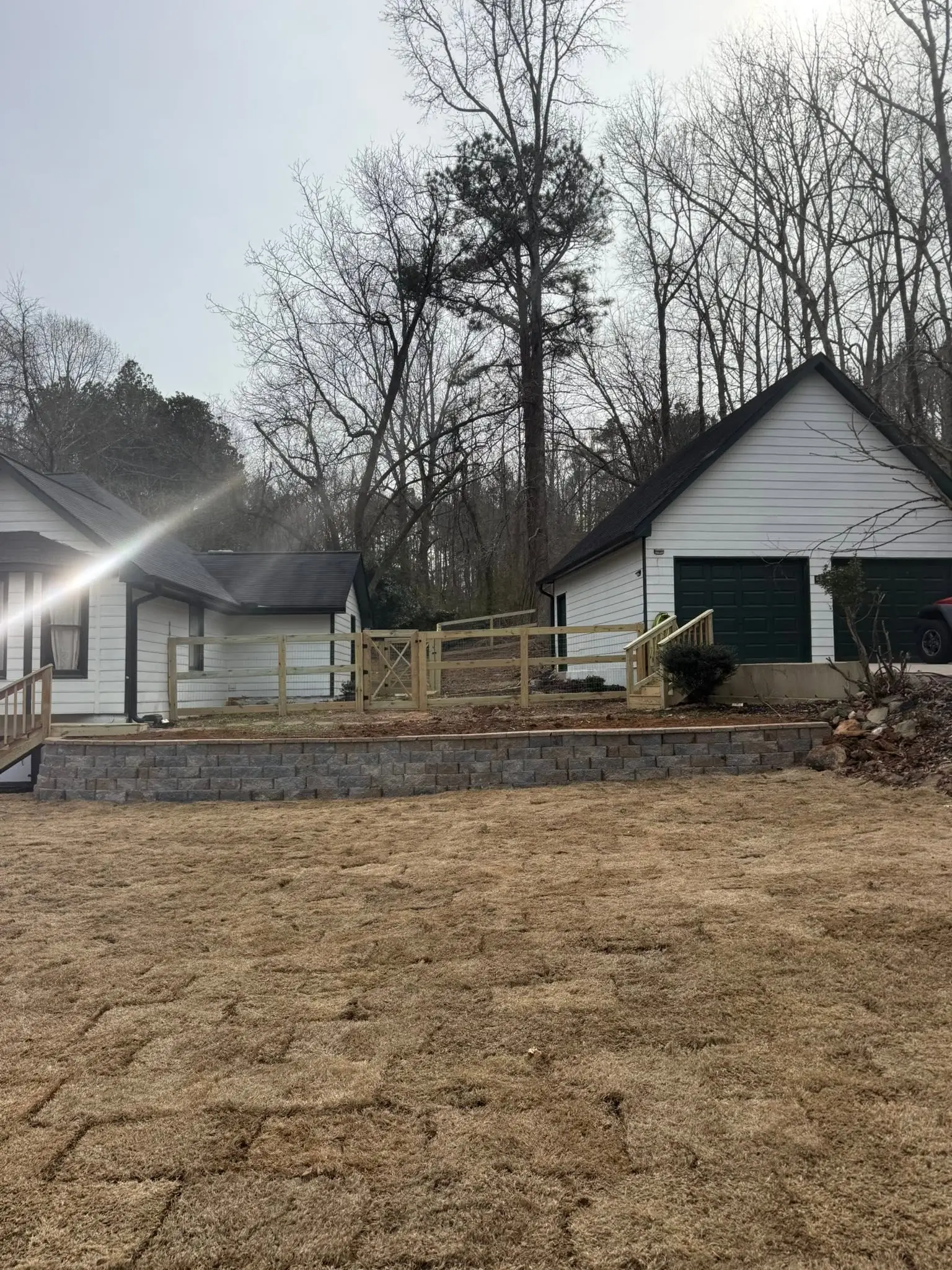 Wood fence and block retaining wall on a farm property
