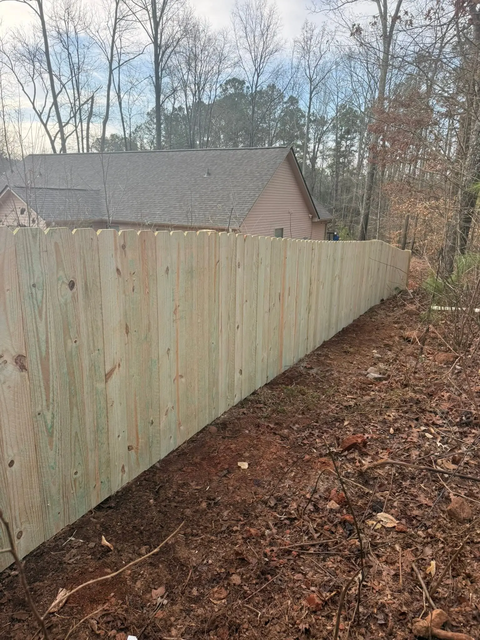 New stockade privacy fence line ready for stain