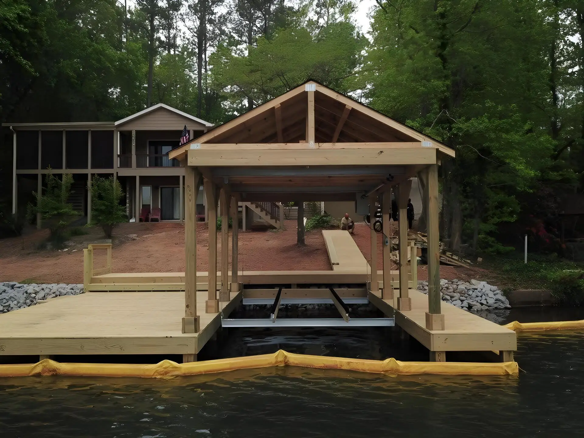 New boathouse framing and boat lift on a pressure-treated dock