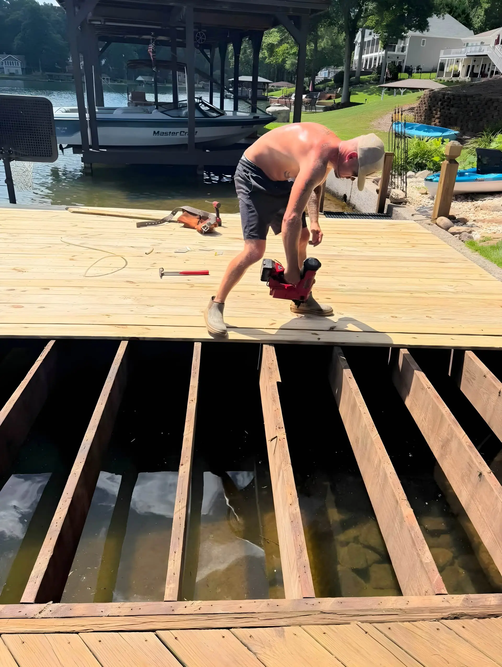 Crew installing dock decking with a nail gun