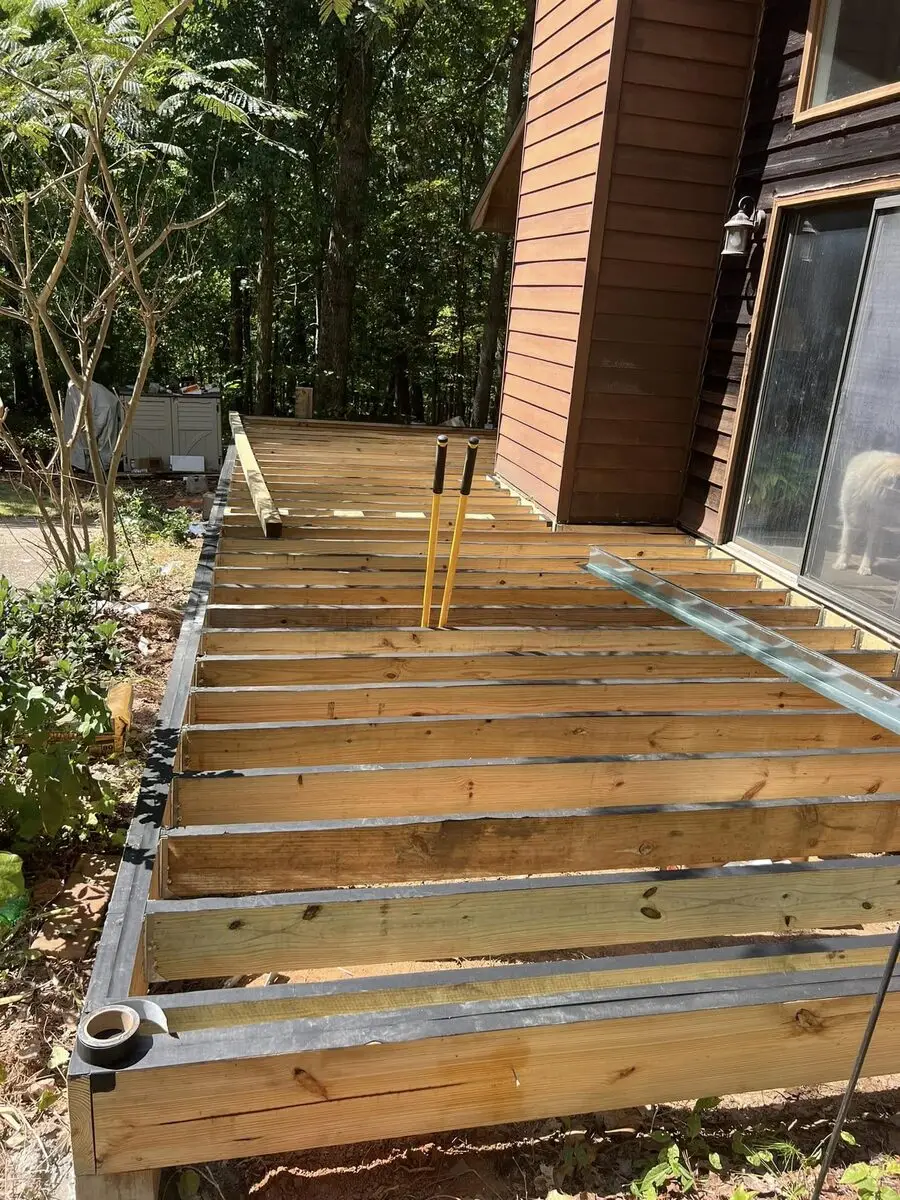Deck framing in progress with joist flashing tape installed