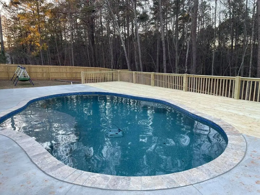 New pressure-treated pool deck at dusk in Villa Rica
