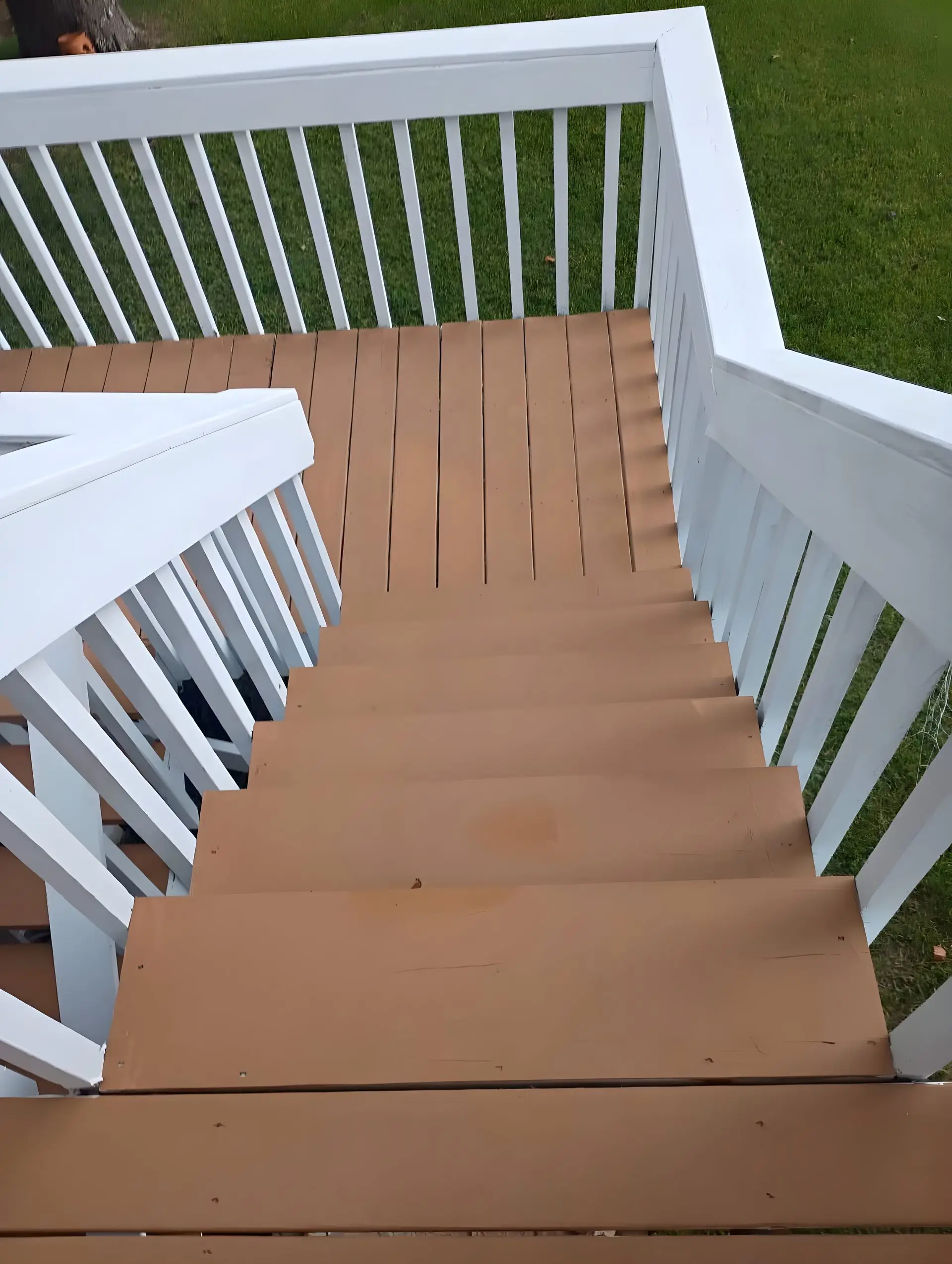 Finished stained deck with white rail and matching stairs.